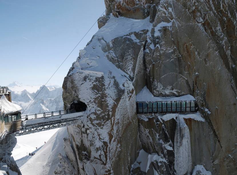 Passarela e túnel encravado no Mont Blanc, em <a href="https://viajeaqui.abril.com.br/materias/esqui-e-vida-selvagem-na-francesa-chamonix" rel="Chamonix" target="_blank">Chamonix</a>, nos <a href="https://viajeaqui.abril.com.br/cidades/franca-alpes-franceses" rel="Alpes Franceses" target="_blank">Alpes Franceses</a>; sede das primeiras Olimpíadas de Inverno, a cidade começou a atrair exploradores em 1741, hipnotizados pelo glaciar que cobria a base do vale