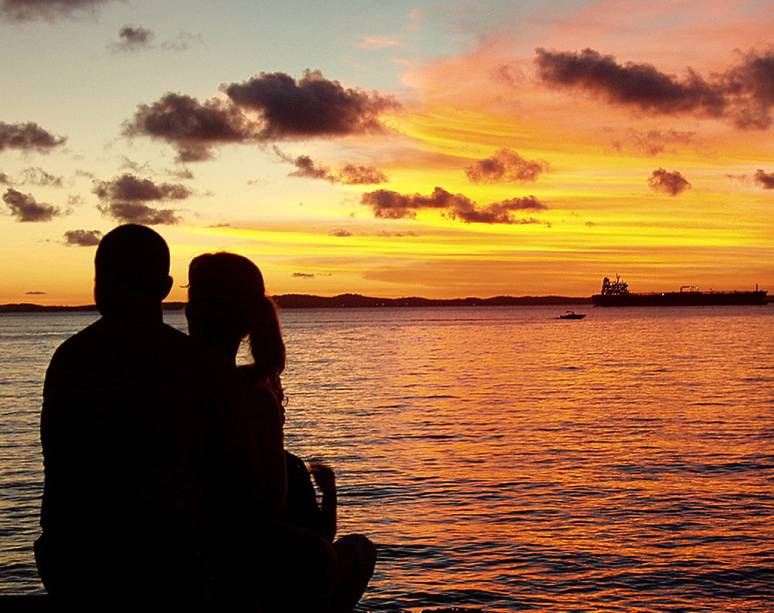 Jovem casal contempla o pôr do sol no <a href="https://viajeaqui.abril.com.br/estabelecimentos/br-ba-salvador-atracao-museu-de-arte-moderna-solar-do-unhao" rel="Solar do Unhão" target="_self">Solar do Unhão</a>, <a href="https://viajeaqui.abril.com.br/cidades/br-ba-salvador" rel="Salvador" target="_self">Salvador</a>, <a href="https://viajeaqui.abril.com.br/estados/br-bahia" rel="Bahia" target="_self">Bahia</a>