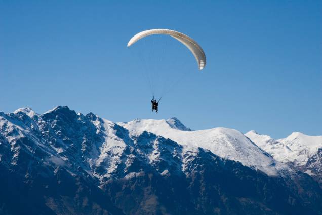 Paragliding em Queenstown, que conta com muitas agências especializadas em esportes radicais Paragliding em Queenstown, que conta com muitas agências especializadas em esportes radicais
